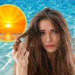 Ragazza con capelli rovinati al mare