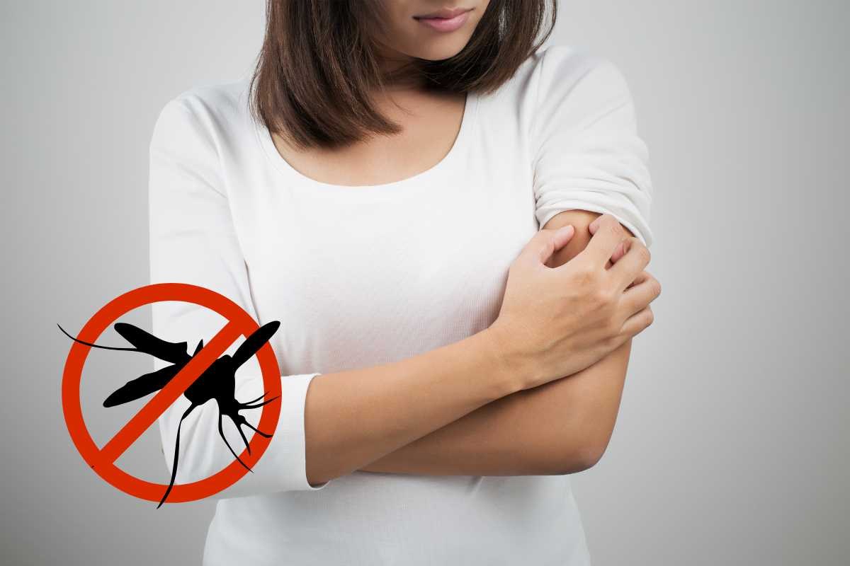 ragazza si gratta braccio, simbolo stop zanzara
