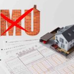 modellino di casa e scritta barrata IMU