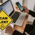 WhatsApp su pc e smartphone e cartello allerta truffa