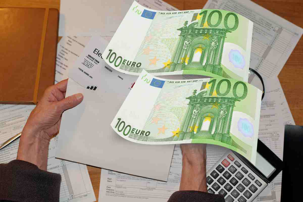 Bollette e due banconote da 100 euro