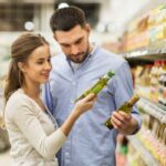 uomo e donna che scelgono l'olio al supermercato